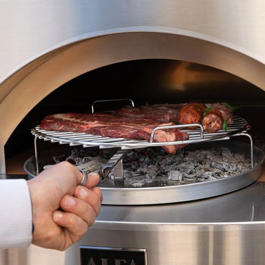 Alfa BBQ with man pushing the metal grill rack inside the stainless steel oven with food on it.