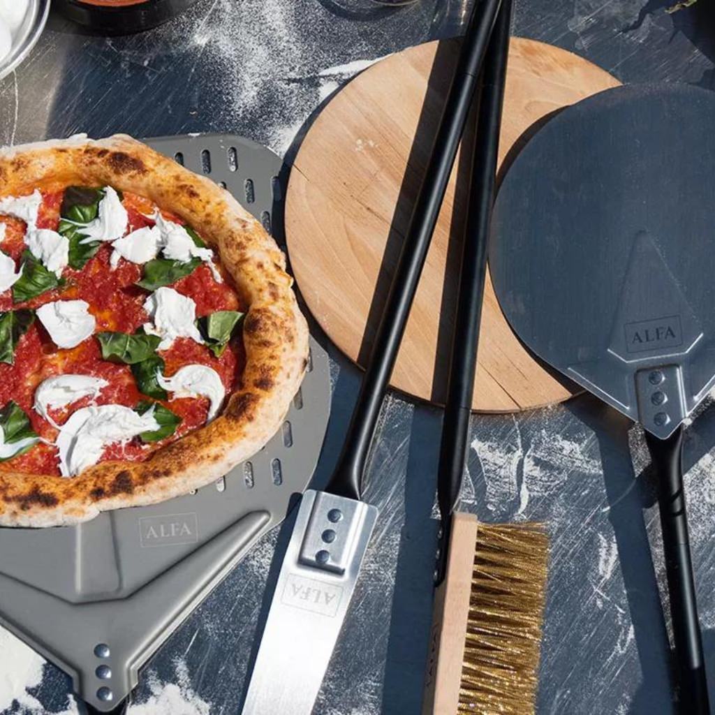Alfa Pizza Peel Set on stainless steel prep table with margherita pizza on large peel in outdoor kitchen