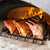 Chicago Brick Oven CBO 750 Wood Fired Pizza Oven DIY Kit Cooking Ribs with Oven Door Open and Wood Burning in the Oven