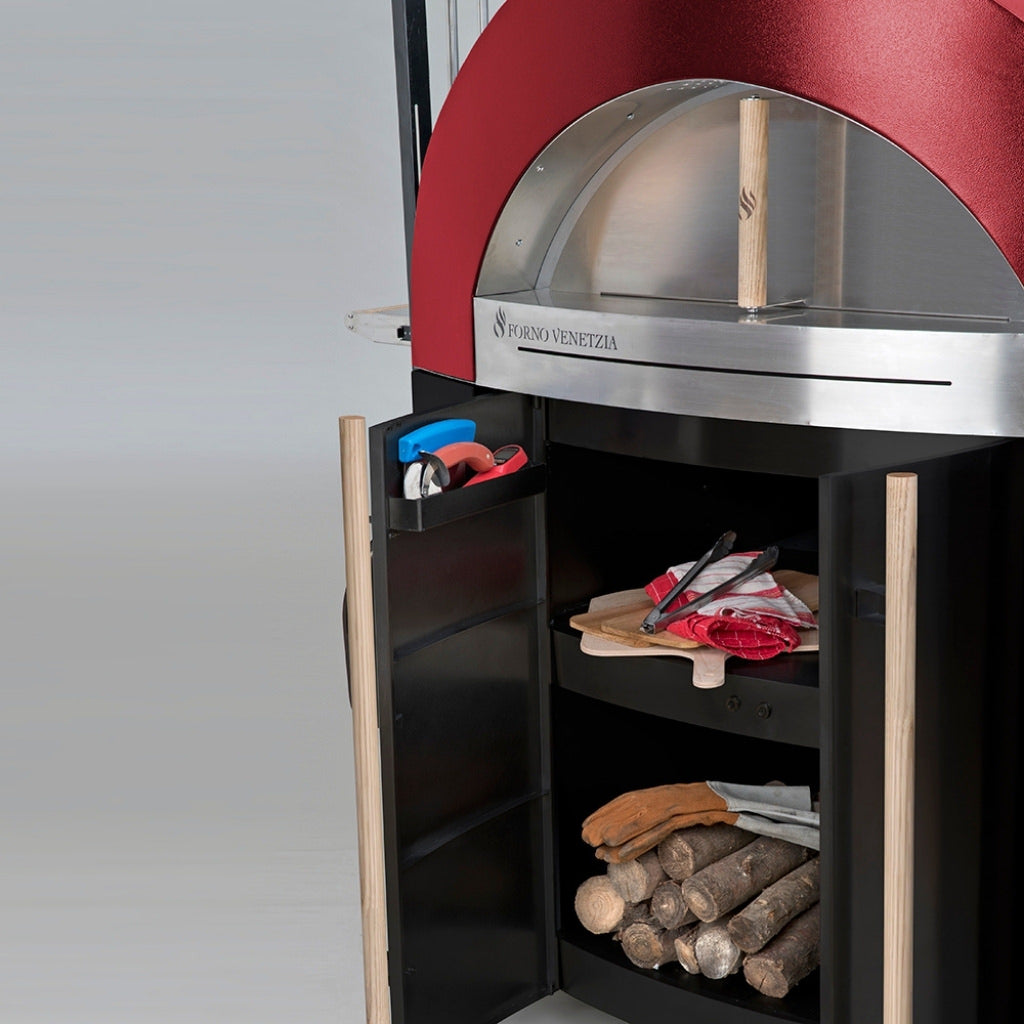 Forno Venetzia Bellagio 300 Mobile Wood Fired Pizza Oven in Red Close Up View of Black Cart Shelving with Cooking Utensils and Cooking Wood Inside.
