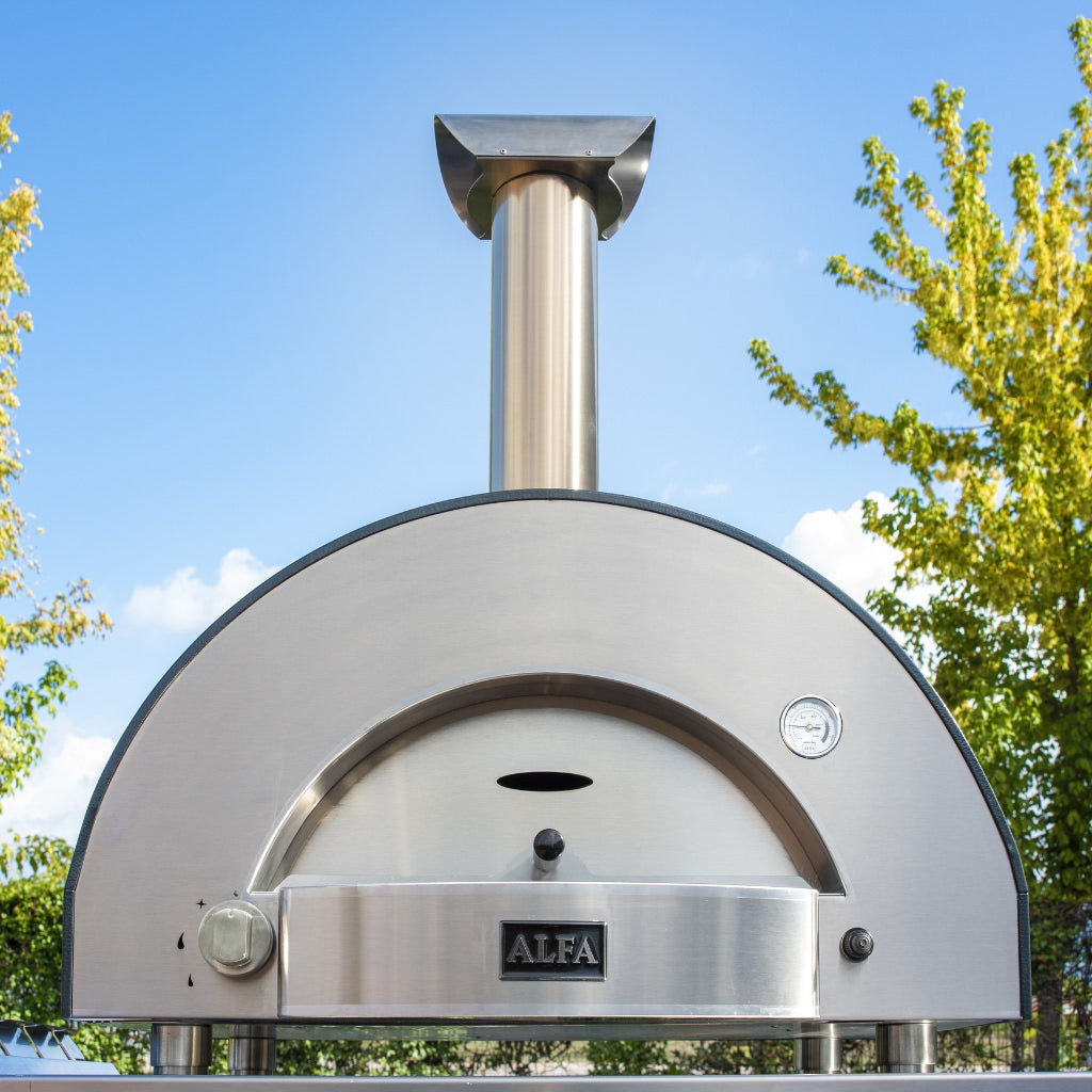 Alfa Forni classico 2 pizza oven in backyard on table with blue skies behind it