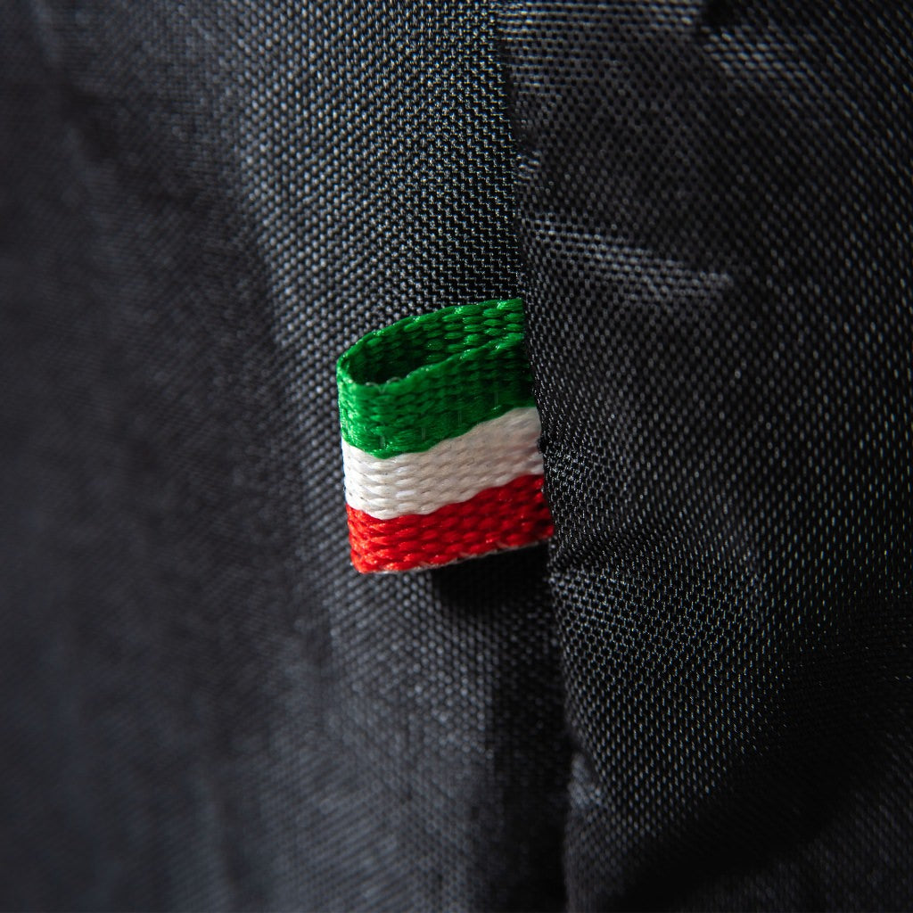 Alfa 5 Minuti Cover textile tag with green, white, and red stripes on a black fabric background