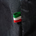 Alfa 5 Minuti Cover textile tag with green, white, and red stripes on a black fabric background