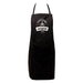A black pizza kitchen apron with a white circular 'Alfa Forni Original' logo printed on the chest, featuring neck and waist straps and a front pocket, shown against a plain white background.
