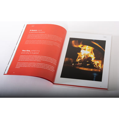 Alfa Forni Cookbook open with a page showing text and another with a photograph of flames.