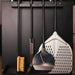 Alfa Forni Cooking Station built in peel holder close up view of pizza tools hanging on side.
