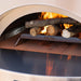 Alfa Forni Hybrid Kit inside pizza oven with wood burning on wood holder and gas burner cover in view