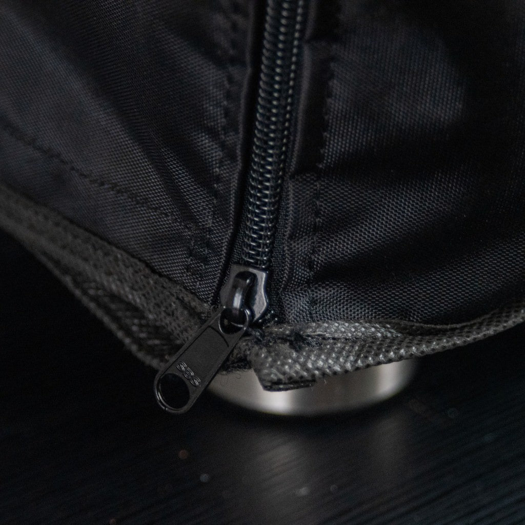 Alfa Moderno Portable Pizza Oven Cover close-up of a black zipper to the feet on a textured surface