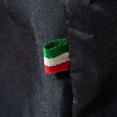 Alfa Nano Cover textile tag with green, white, and red stripes on a black fabric background