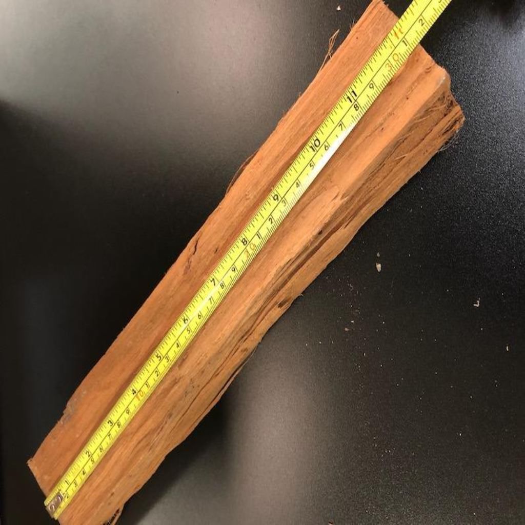 Alfa Pizza Oven Wood with a measuring tape to show length on a black table top