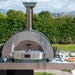 Forno Alfa Classico 2 Pizze Gas Pizza Oven on a stainless steel preparation table in an outdoor space