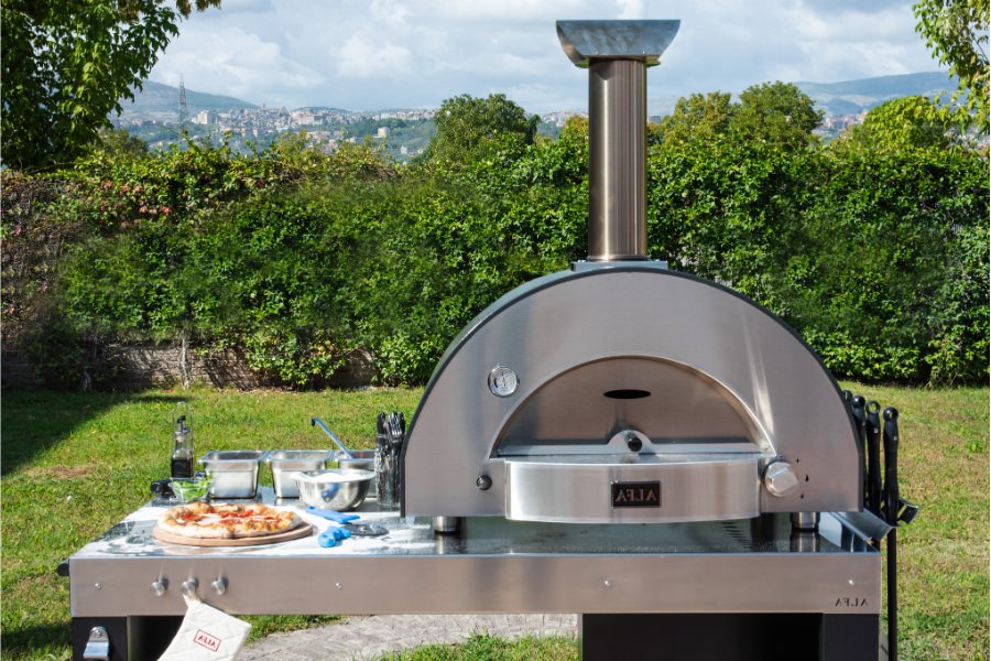 Forno Alfa Classico 2 Pizze Pizza Oven in backyard on cooking table cooking pizzas
