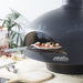 Polito Giotta Pizza Oven pulling a freshly cooked pizza out of the oven on a pizza peel