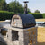 Authentic Pizza Ovens Maximus Arena Countertop Wood Fired Pizza Oven in Black on Custom Built Stone and Concrete Base in Backyard