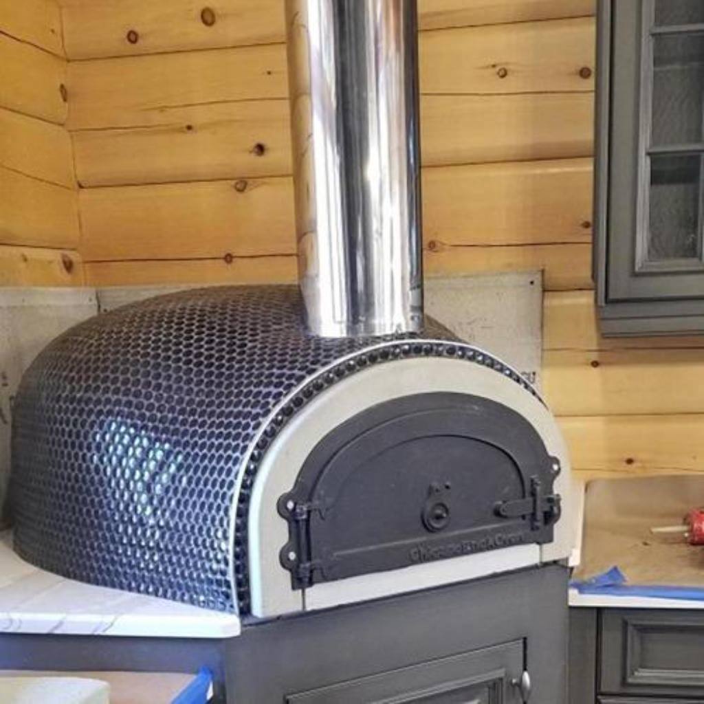 https://propizzaovens.com/cdn/shop/products/Chicago_Brick_Oven_CBO_1000_Commercial_Wood_Fired_Pizza_Oven_Kit_With_Blue_Tile_1200x.jpg?v=1608645892