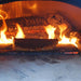 Chicago Brick Oven CBO 500 Countertop Wood Fired Pizza Oven Cooking Fish with Fire Burning in the Background of the Oven