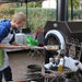 Chicago Brick Oven CBO 500 Countertop Wood Fired Pizza Oven Copper Vein with Man Cooing Pizza on the Back Porch of a Business