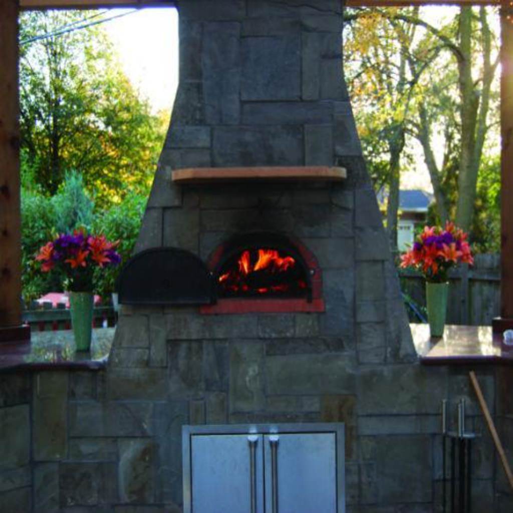 Chicago Brick Oven CBO 500 Wood Fired Pizza Oven Kit Custom Outdoor Kitchen with Dark Stone in Backyard in Summer