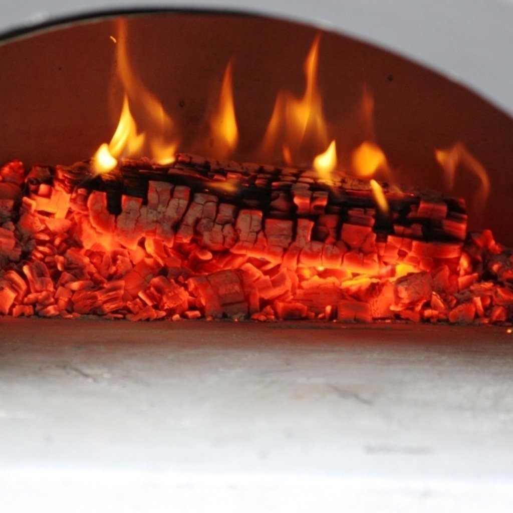 Chicago Brick Oven Mobile CBO 750 Freestanding Wood Fired Pizza Oven Fire Burning Embers Inside Oven Close Up View
