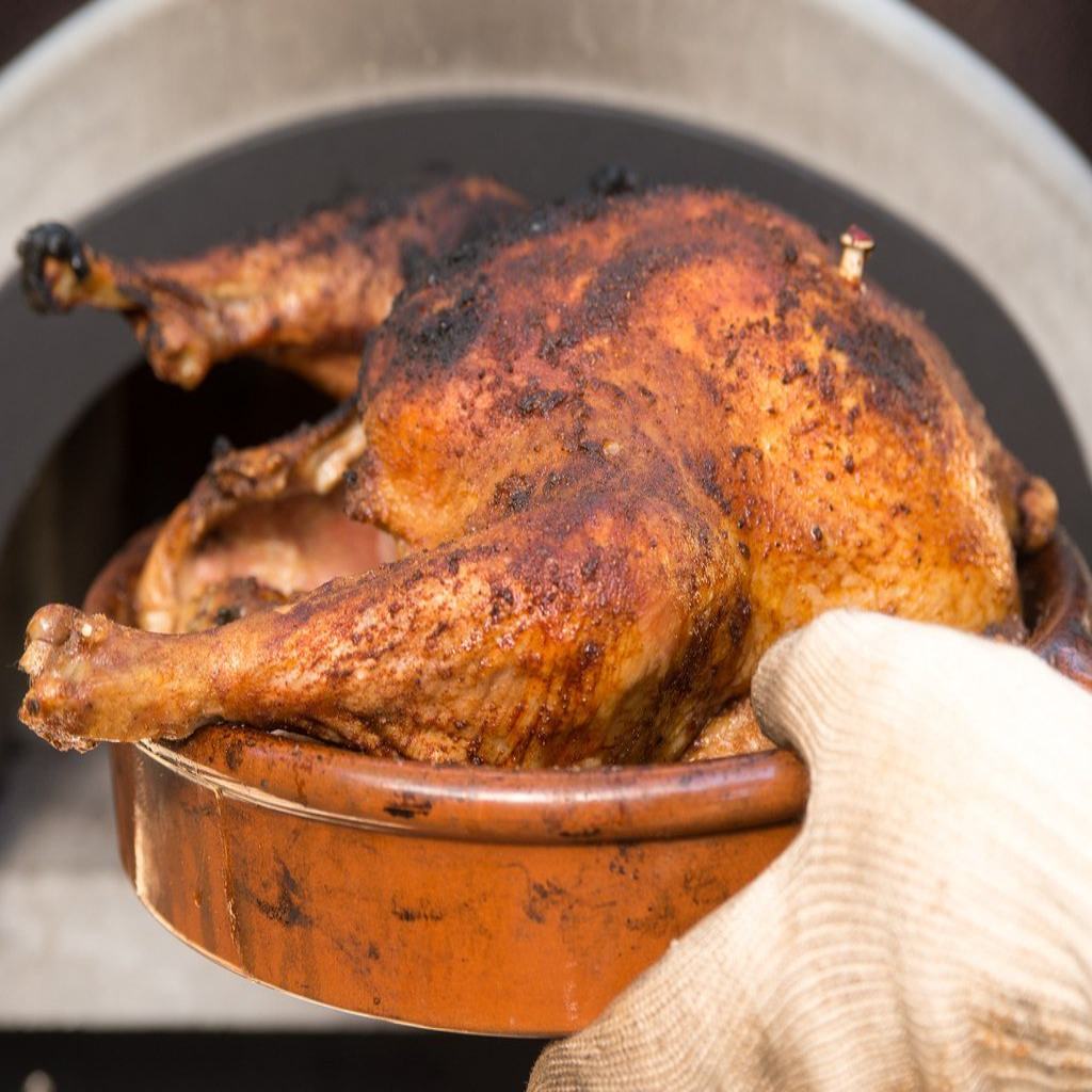 Chicago Brick Oven CBO 750 Hybrid Countertop Gas and Wood Fired Pizza Oven Cooking Whole Chicken in Clay Pan