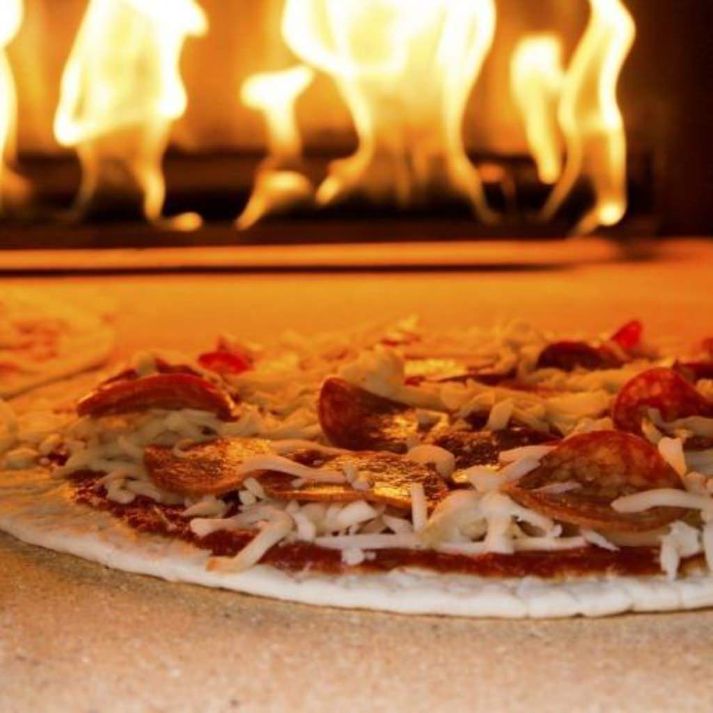 Chicago Brick Oven CBO 750 Hybrid Gas and Wood Fired Pizza Oven DIY Kit Cooking Pizza with Fire Burning in the Oven